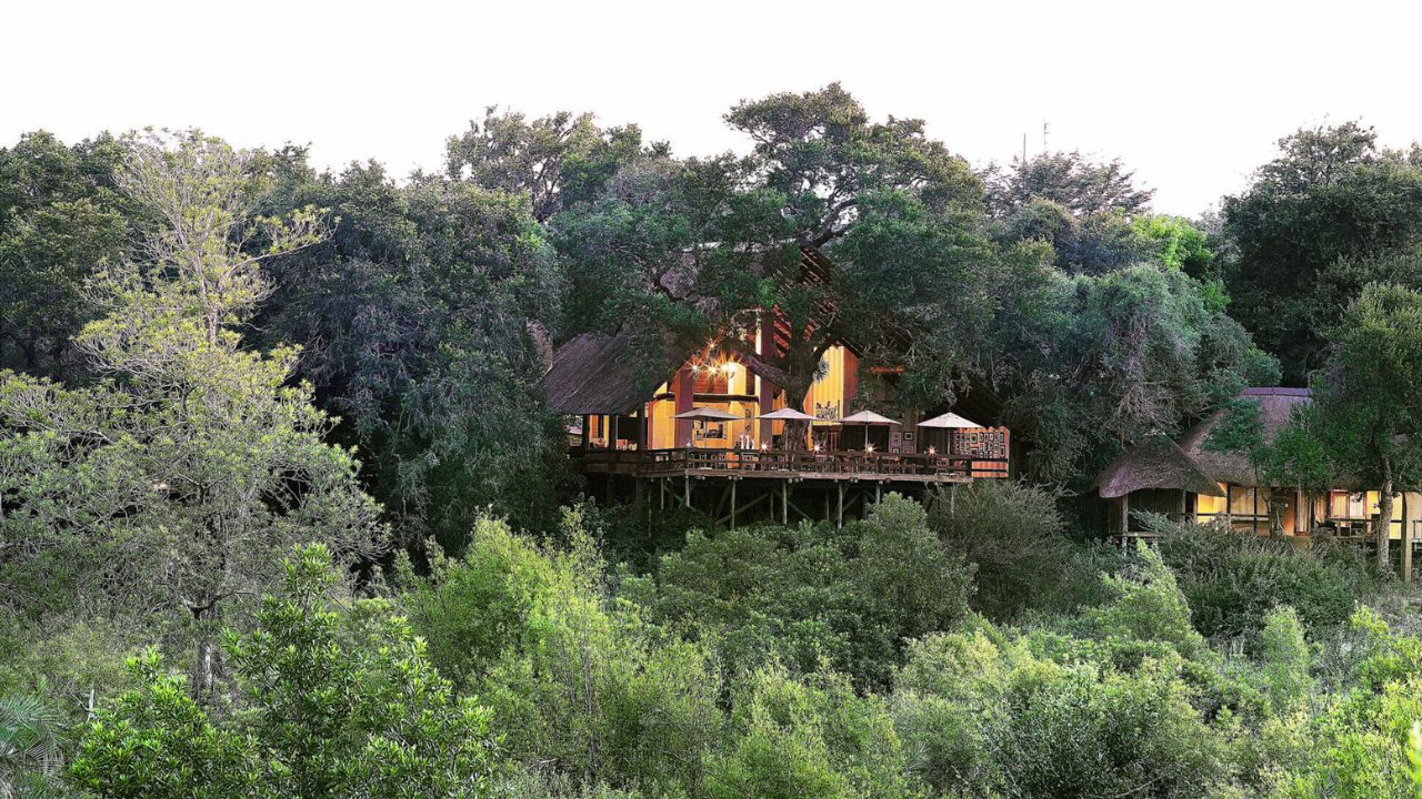 Londolozi Varty Camp main lodge at sunset with thatched roof in bush setting