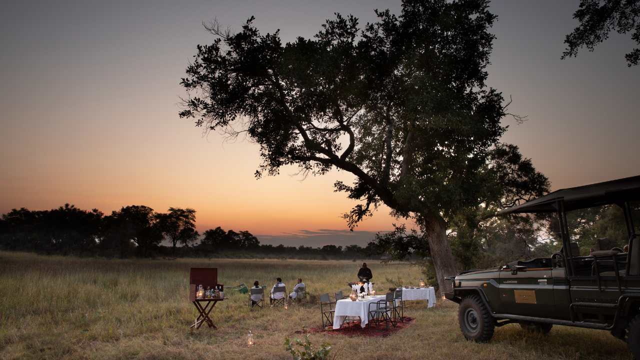 Safari vehicle set up for sunset drinks in Botswana’s Okavango Delta at Duba Explorers Camp.