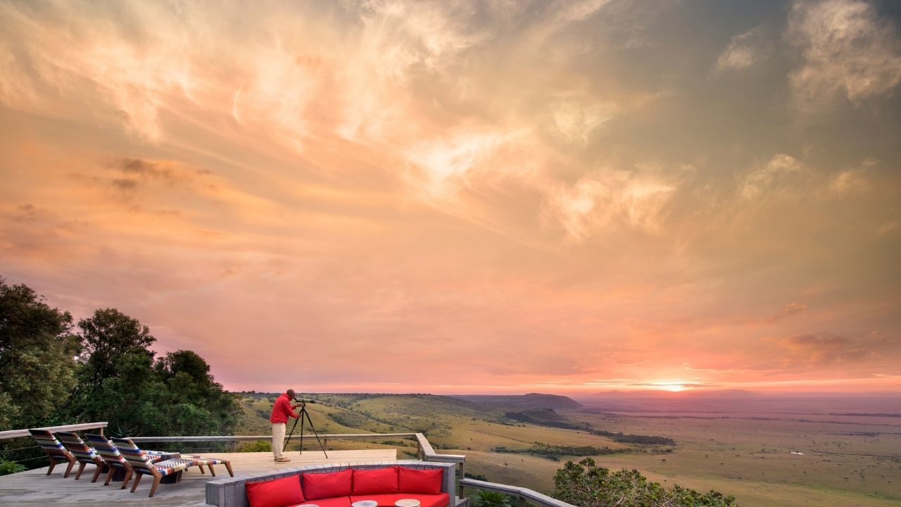 Sunset over Angama Mara Camp with Maasai Mara landscape in the background, Kenya safari.