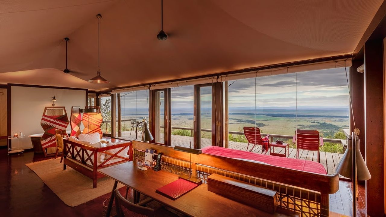 View from study desk in guest suite at Angama Mara Safari Camp, overlooking room, deck, and Maasai Mara plains, Kenya.