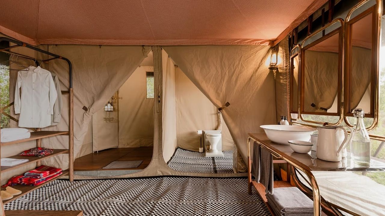 Tented suite with private bathroom at Angama Mara safari camp, Maasai Mara, Kenya, with bush views.