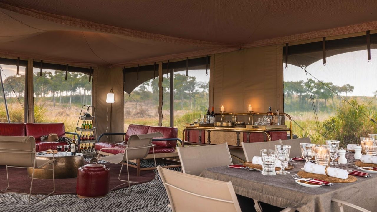 Relaxing lounge area inside a tented suite at Angama Safari, Maasai Mara, Kenya, with views of the bush.