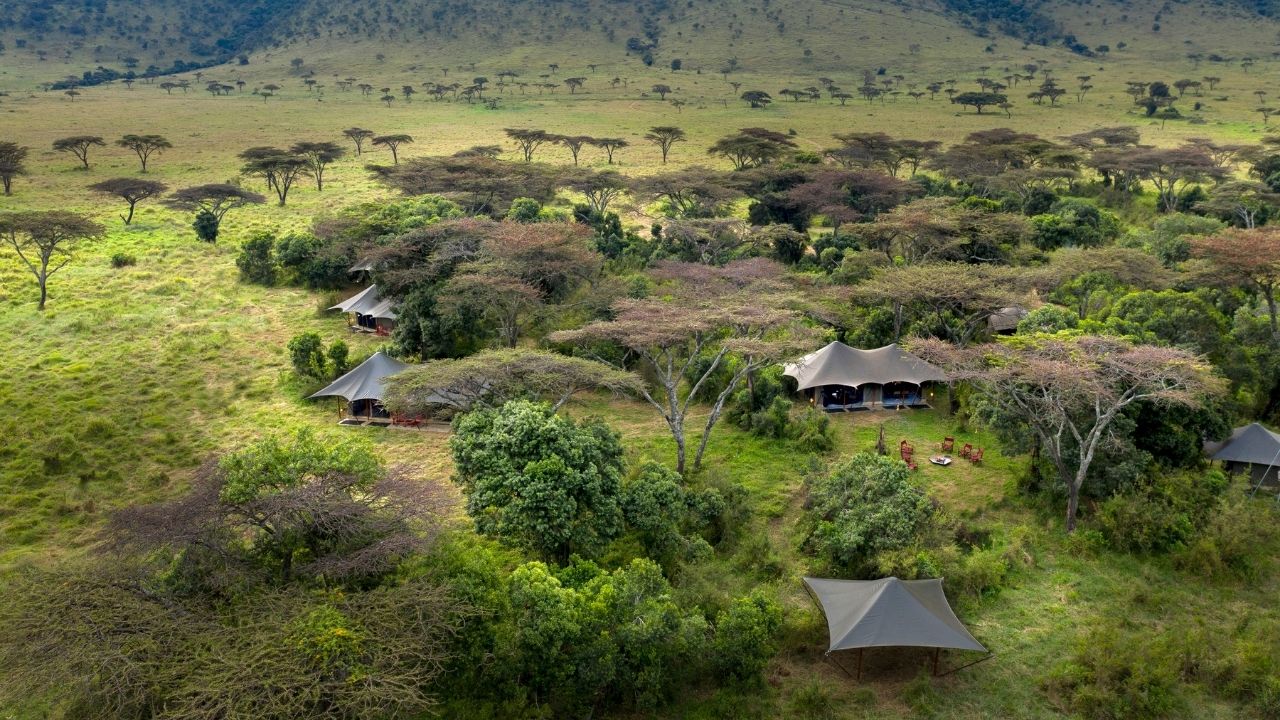 Aerial view of AngamaSafari Camp in Maasai Mara, Kenya, showing tents, deck areas, and surrounding bush.