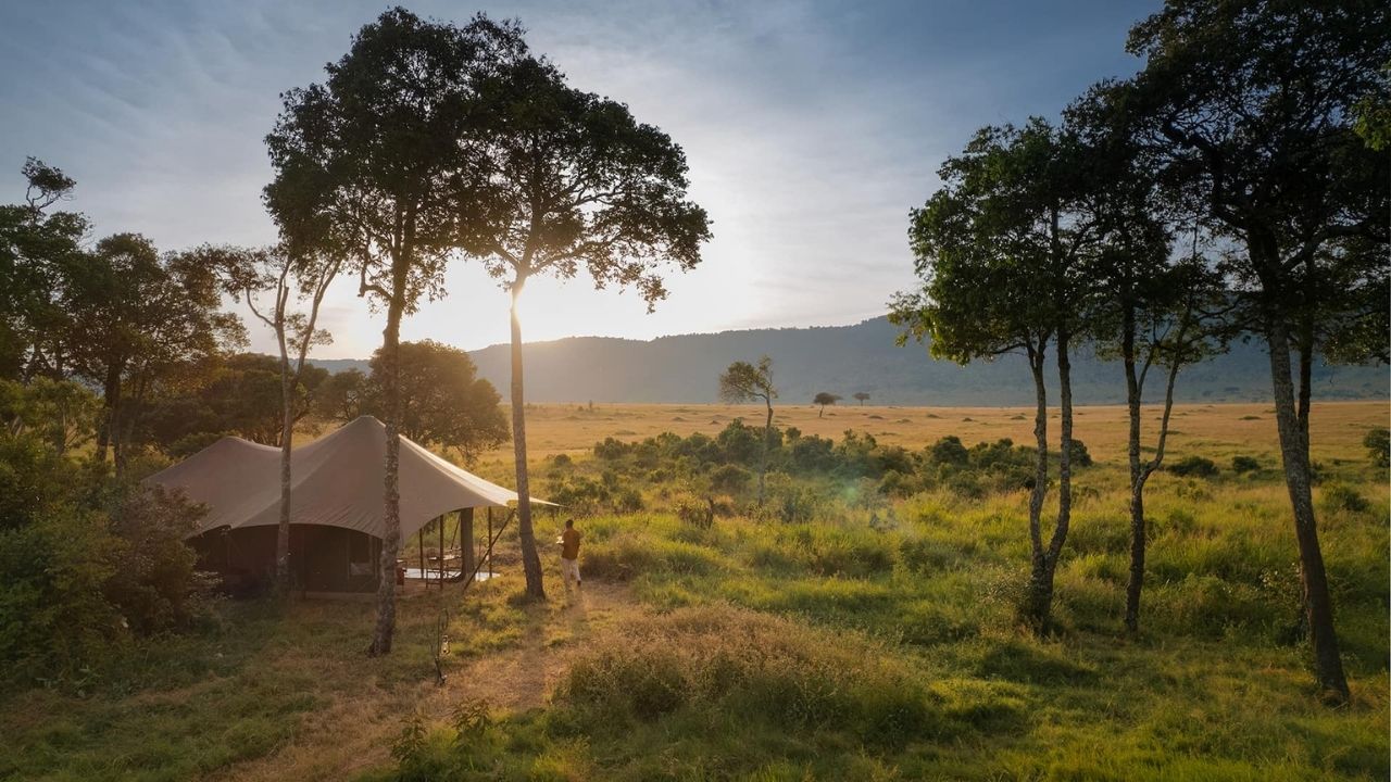 Exterior view of Angama Mara Safari Camp guest suite with Maasai Mara bush in the background, Kenya.