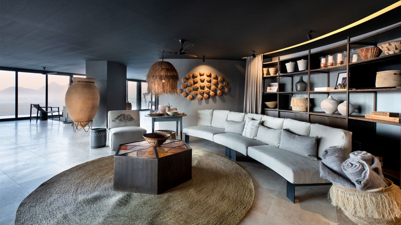 Interior reception area of Sossusvlei Desert Lodge with modern desert-style decor and long couch