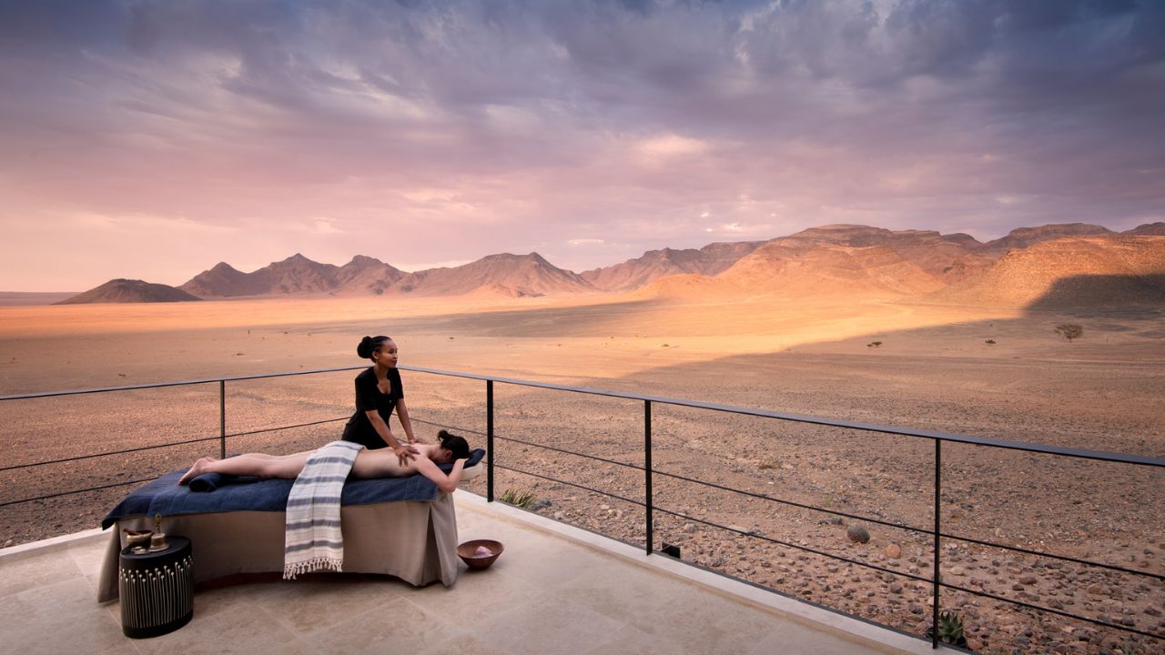Guest enjoying massage in open area overlooking Namib Desert plains