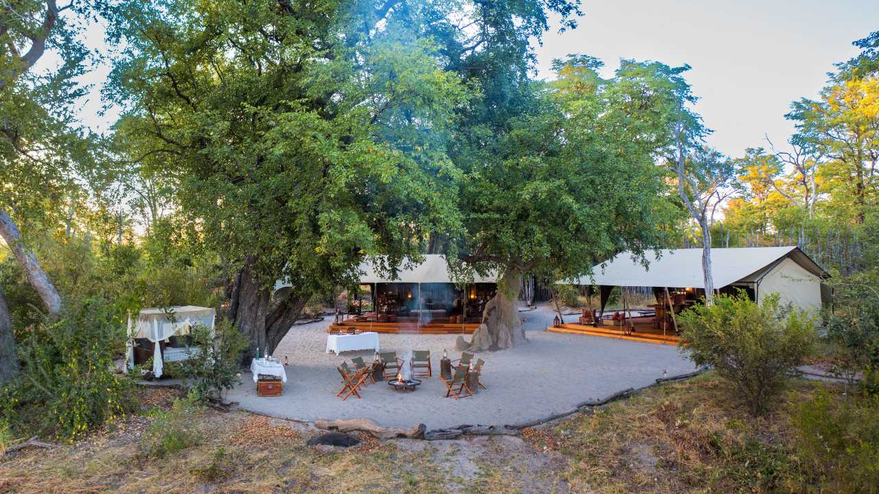 Guests gather around the campfire at Selinda Camp’s main lodge in Botswana.
