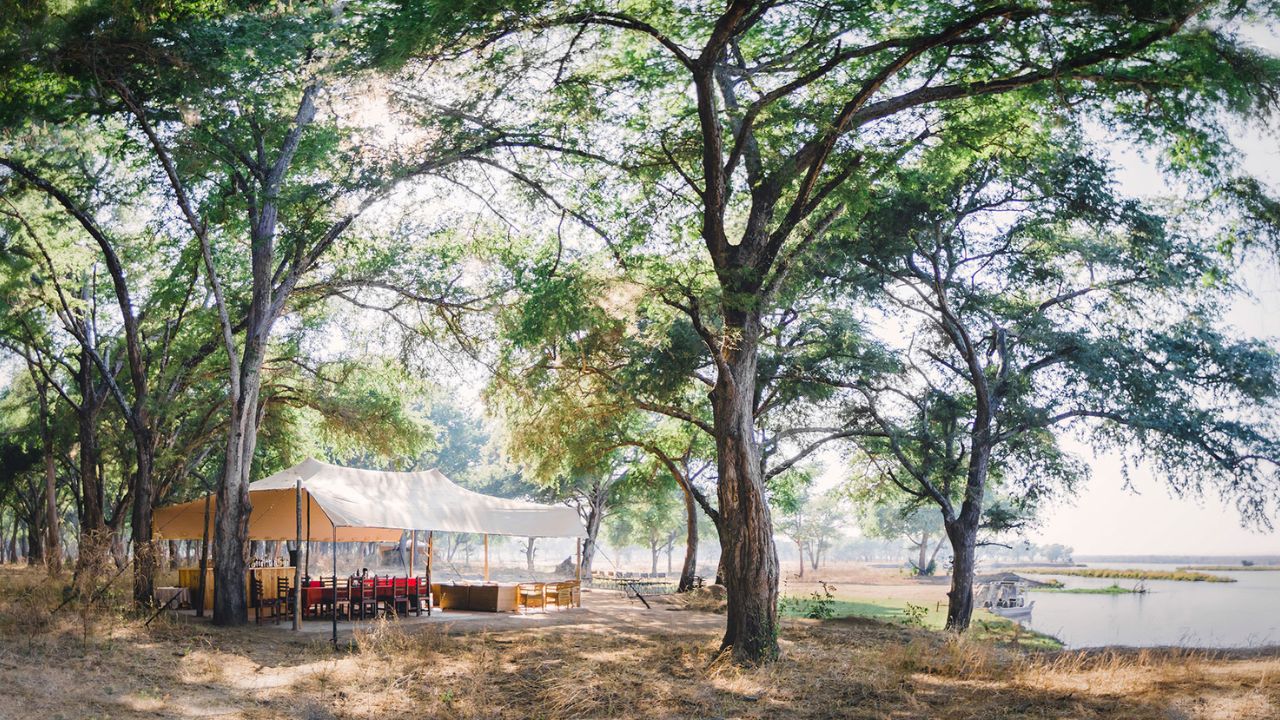 Dining tent at Kutali Safari Camp next to the lake, Lower Zambezi National Park, Zambia, in sunshine.