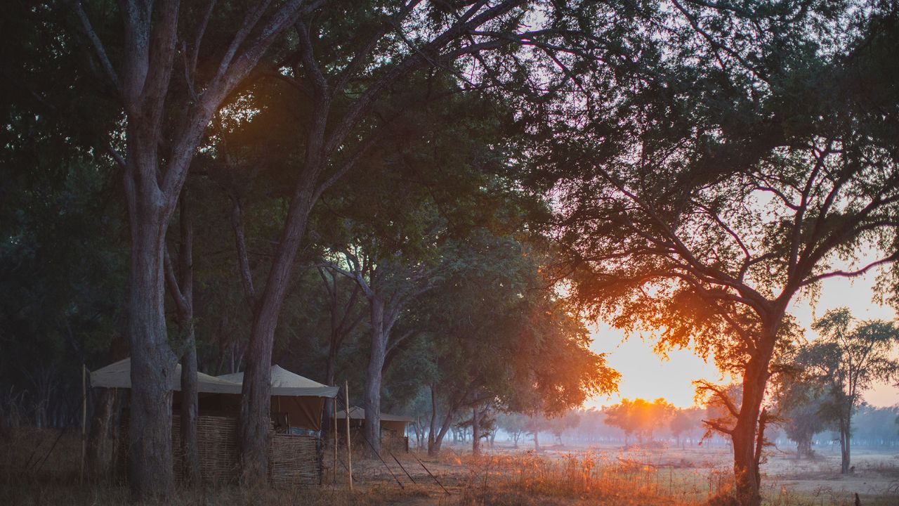 Red sunset over guests’ tented accommodation at Kutali Safari Camp, Lower Zambezi National Park, Zambia.
