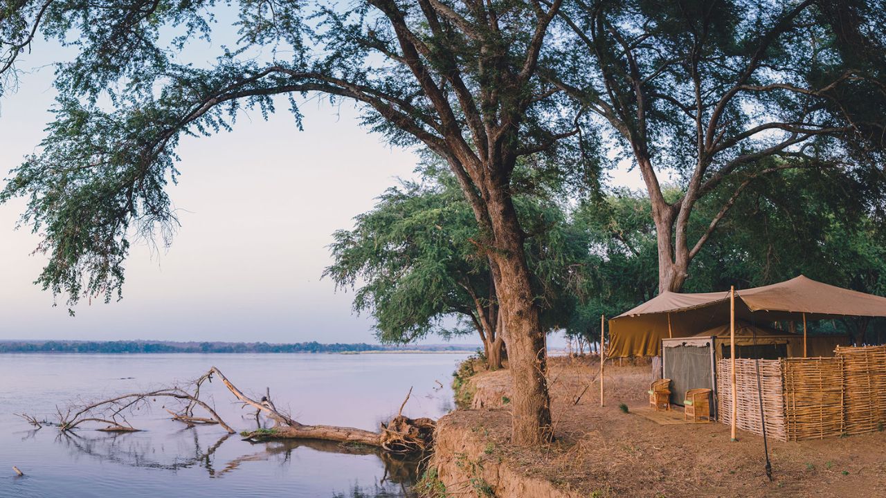 Outside view of tented accommodation at Kutali Safari Camp next to the river, Lower Zambezi National Park, Zambia.