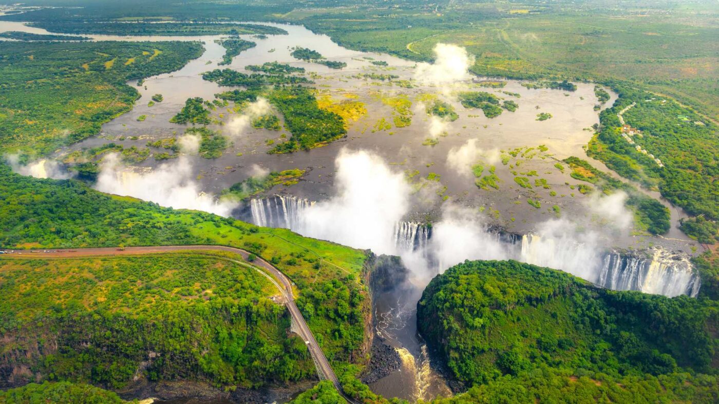 Aerial shot of Victoria fall in full flood in Summer with bridge in foreground