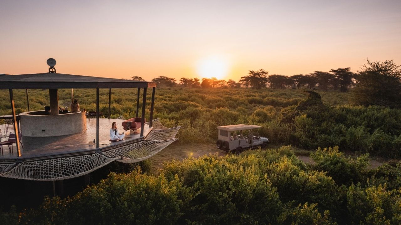 Sunset over elevated lookouts in Angama Amboseli, Kenya, with panoramic Maasai Mara safari views.