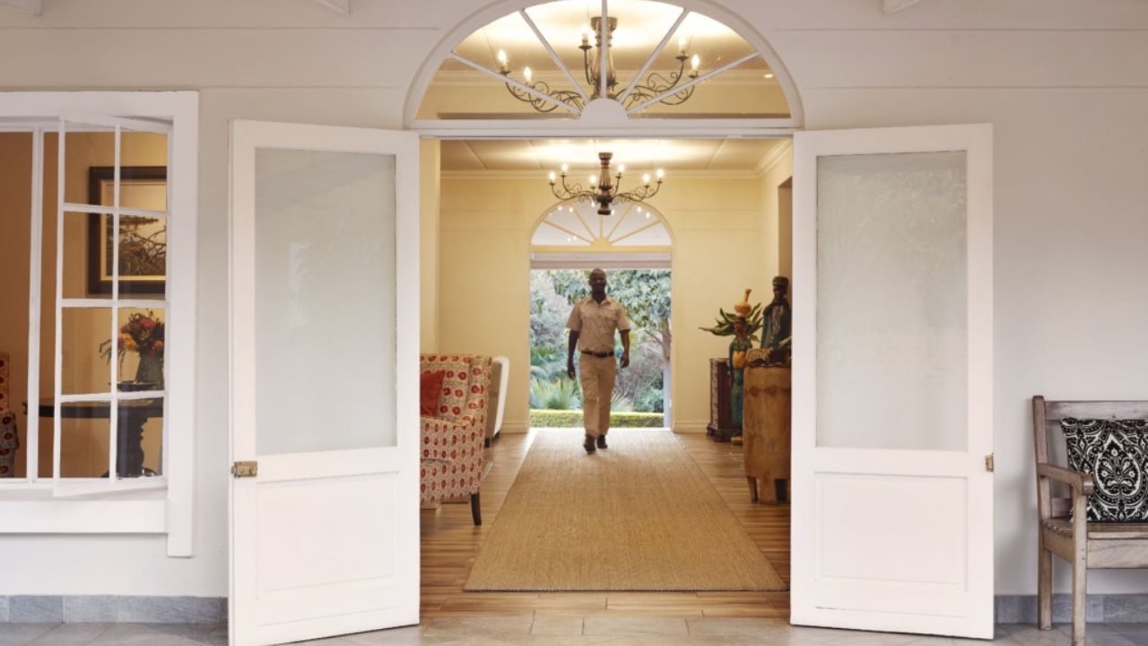 Entrance hall of Batonka Hotel reception with concierge walking toward camera