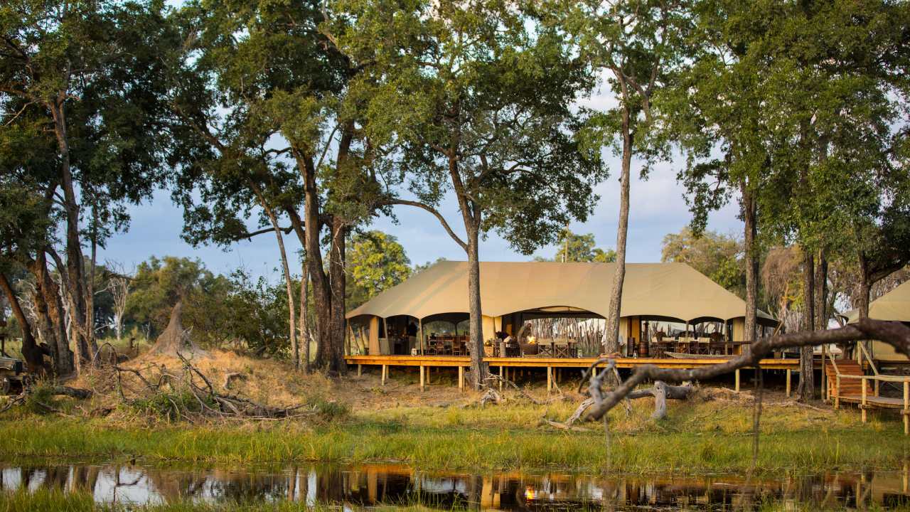 View of the main lodge at Duba Explorers Camp in Botswana across the waterway.