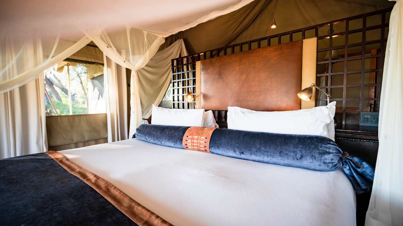 Double bed in the main bedroom at Duba Explorers Camp, Okavango Delta, Botswana.