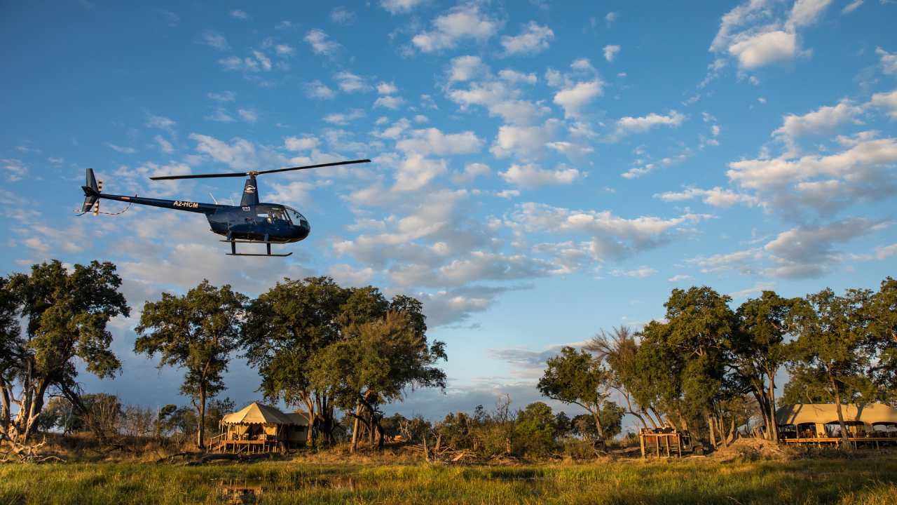 Helicopter taking off for a safari transfer over the main lodge in Botswana’s Okavango Delta.