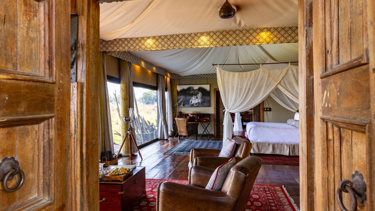 Side view of luxury tented accommodation at Duba Plains Camp with double bed and deck, Botswana.