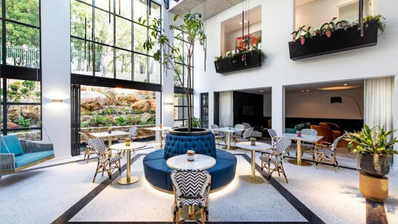 Reception area at Camissa House with high-volume ceiling and airy seating space