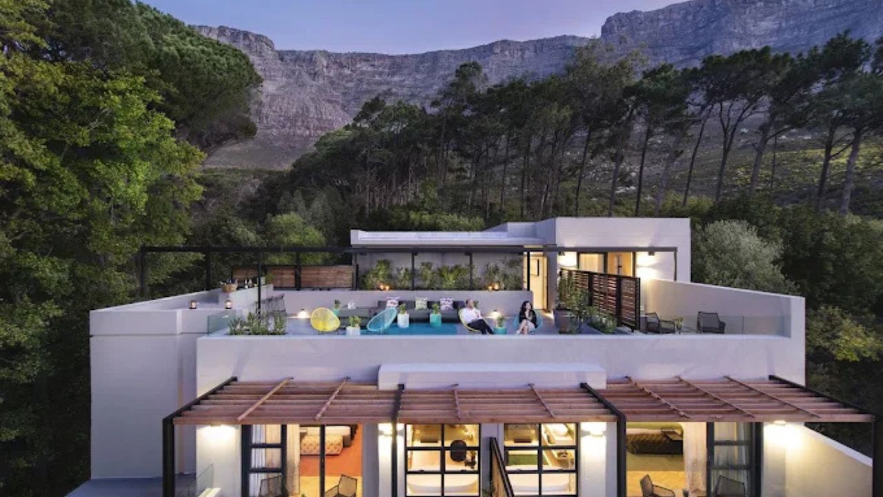 Exterior of Camissa House at sunset with guests on rooftop deck in Cape Town