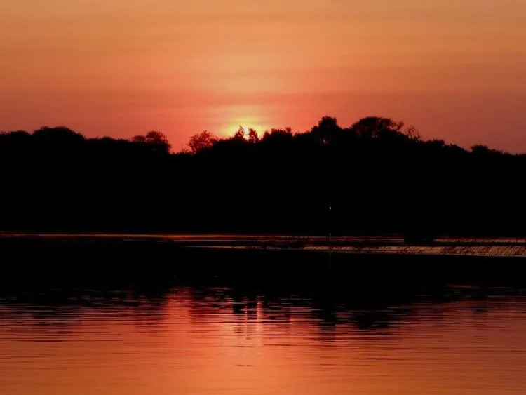 Sunrise over the Zambezi and Small Mountain in silhouette form, Chundukwa Lodge, Zambia.