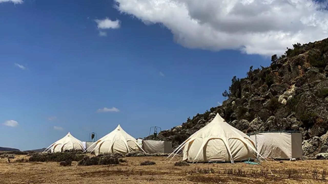 Wide-angle view of Ethiopian tented accommodation on mountain pass