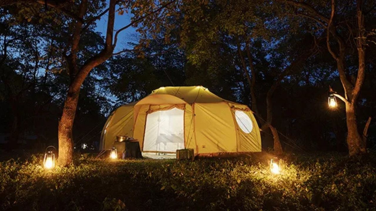 A-frame Ethiopian tented accommodation lit with candles at night
