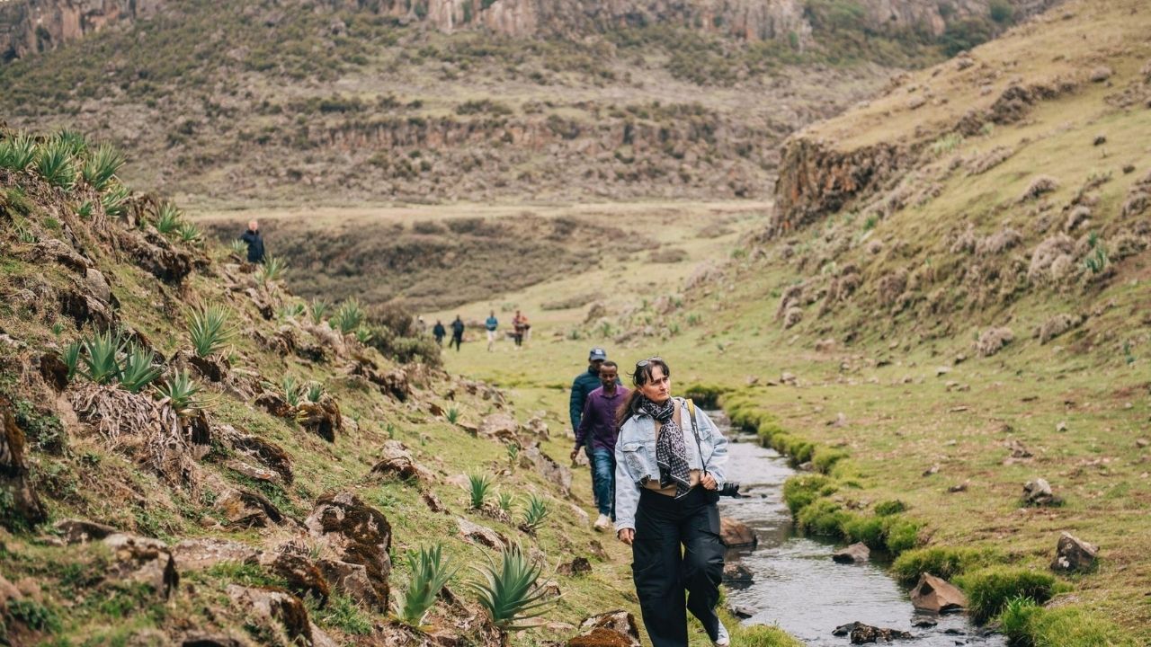 Hikers in Bale Mountains National Park valley with river, Ethiopia