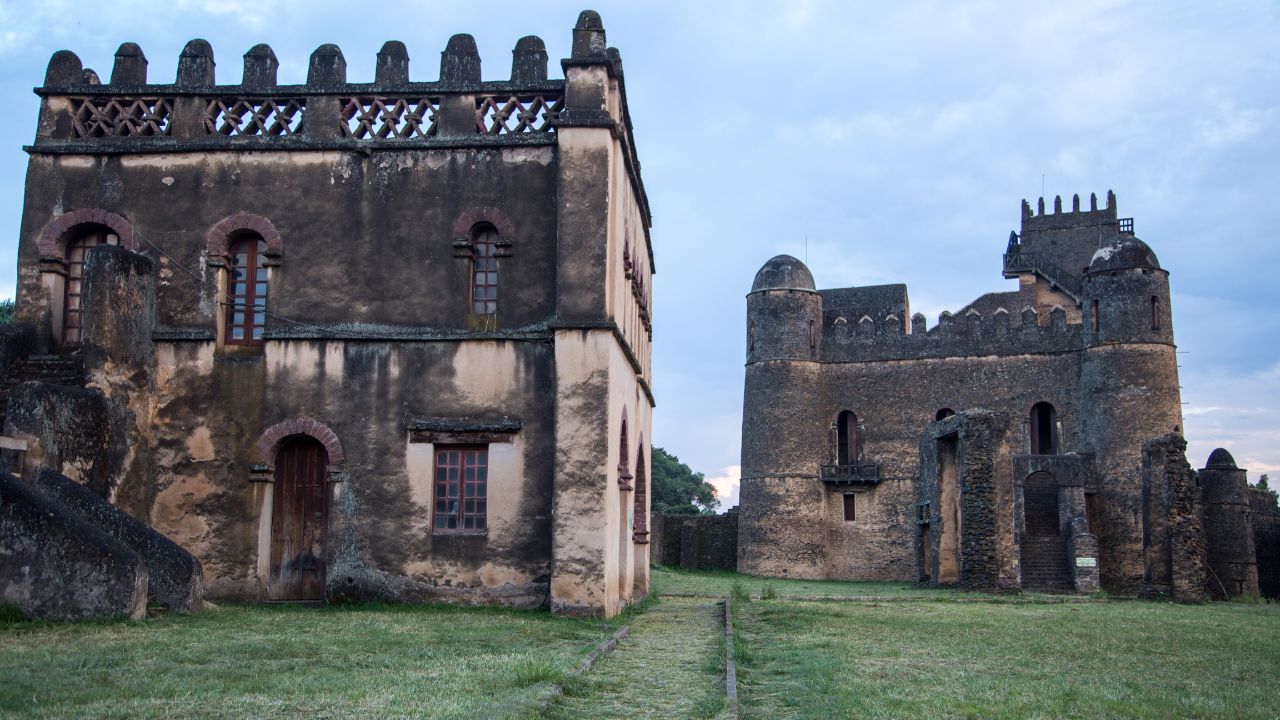 Wide-angle view of Gondar church with blue skies and green lawns, Ethiopia.