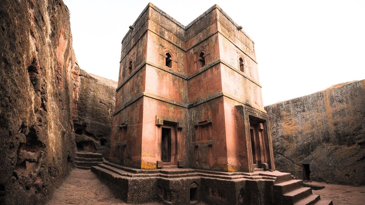 Bottom-up view of orange rock-hewn church, Lalibela Ethiopia