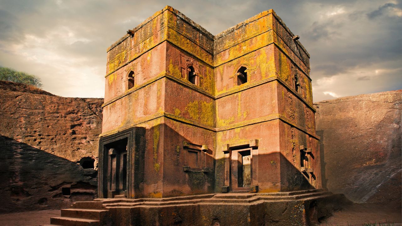 Side view of Lalibela church with sun overhead, Ethiopia