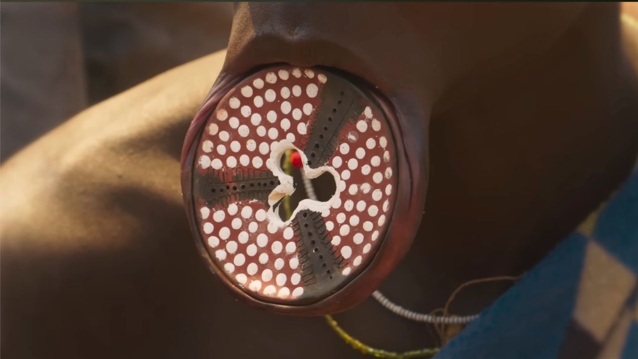 Omo Valley tribal woman with brightly colored lip plate Ethiopia