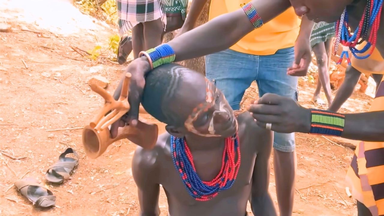 Omo Valley tribal man having traditional face paint applied
