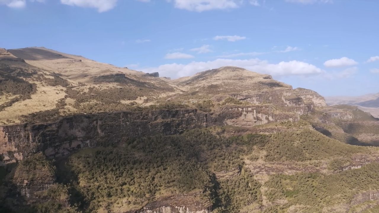 Wide-angle view of Simien Mountains showing vast terrain and mountain peaks, Ethiopia.