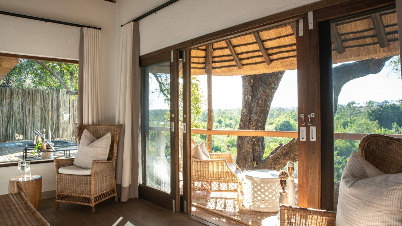 View from inside Londolozi Varty Camp suite looking out onto private deck and bush