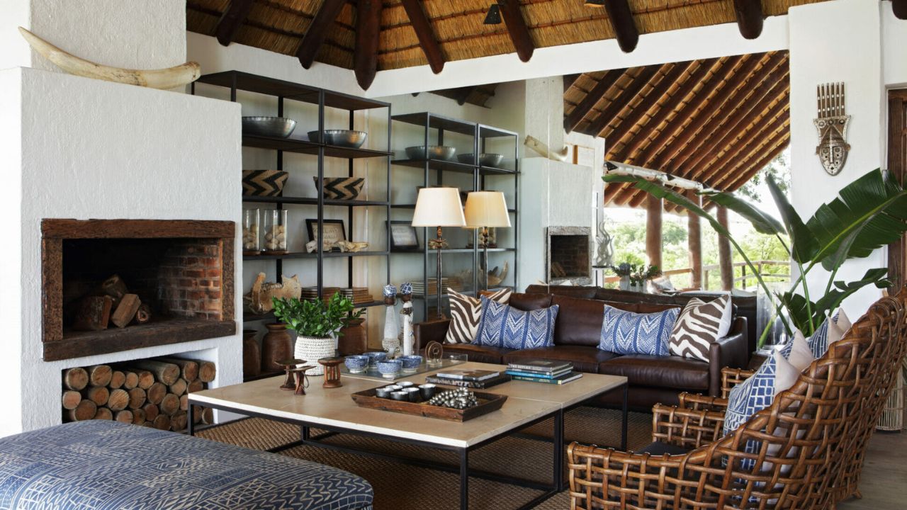 Interior of Londolozi Varty Camp main lodge with bookshelves and lounge seating