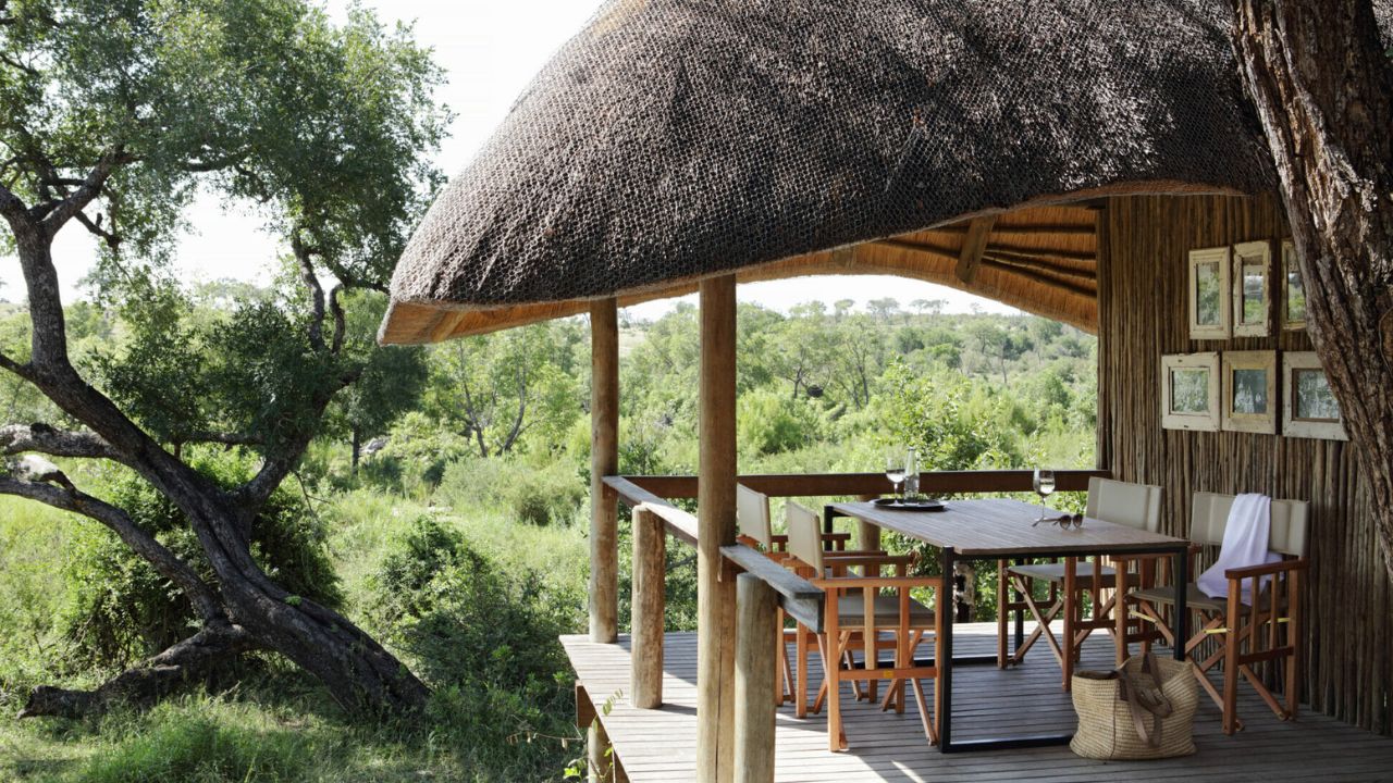 Thatched roof deck dining area with bush views at Londolozi Varty Camp