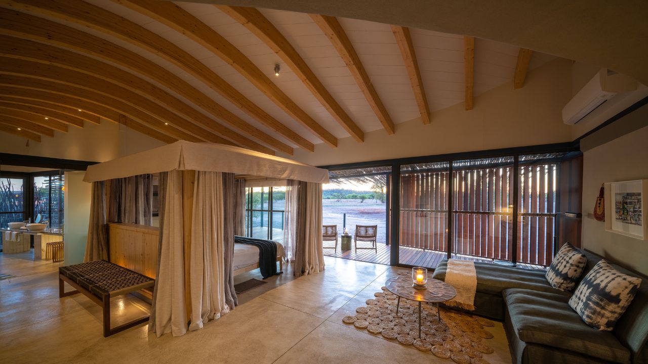 Rear view of guest accommodation with large bay window doors overlooking desert