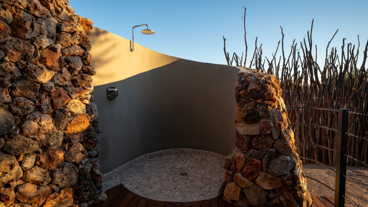 Outdoor shower at guest accommodation offering an immersive African experience