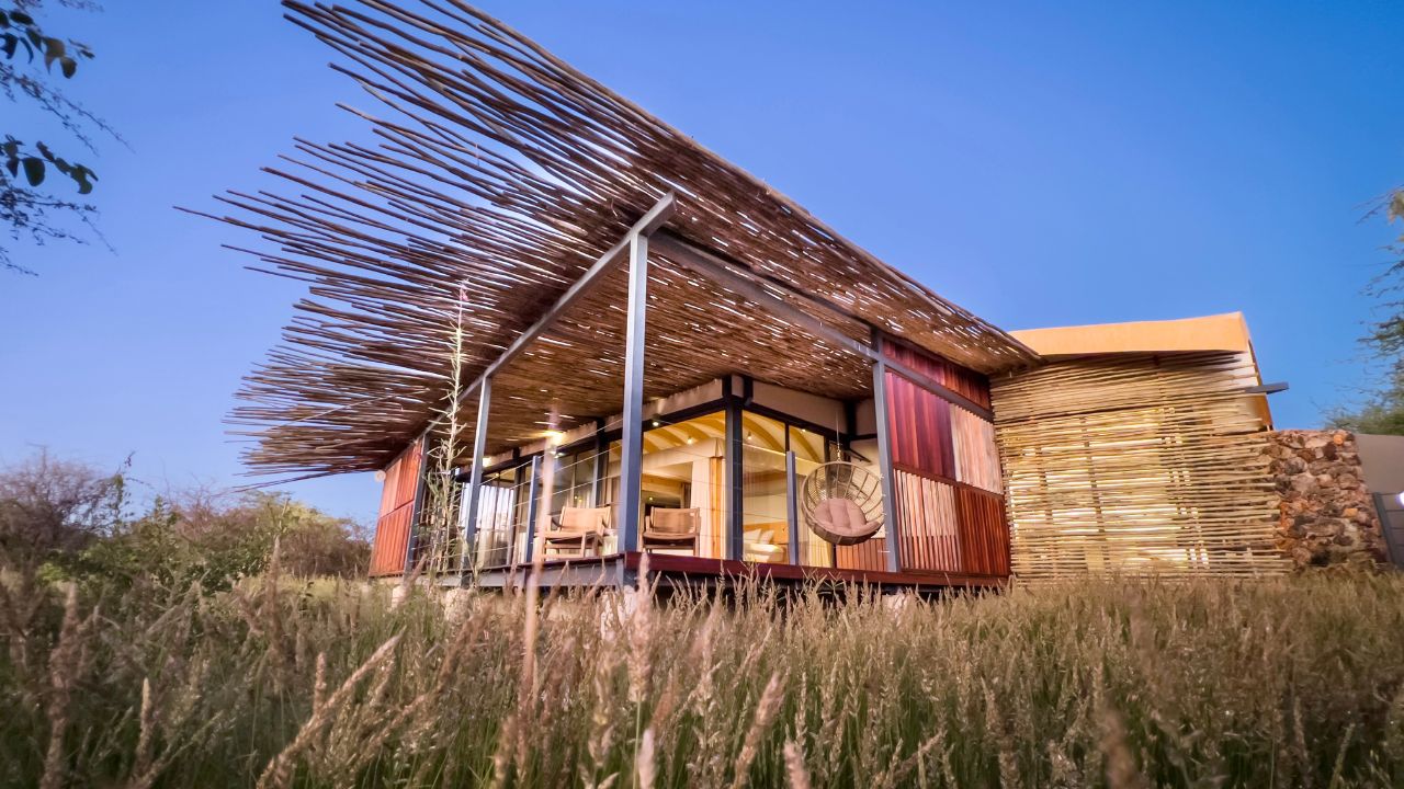 Front view of guest accommodation with thick roof and glass windows
