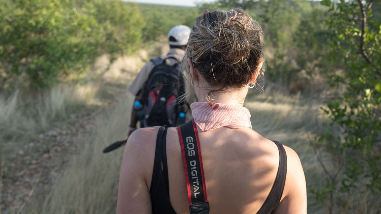 Photographer on walking safari during private photography session in desert