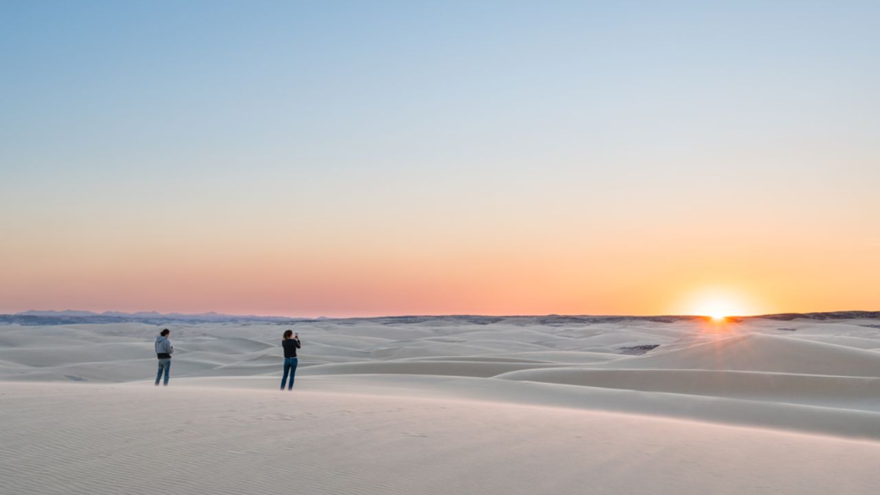 White dunes with red sunset lighting over desert