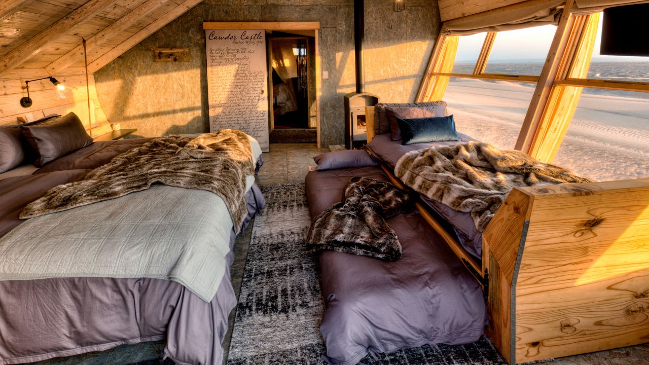 Guest suite inside Shipwreck Lodge with twin beds and modern interior