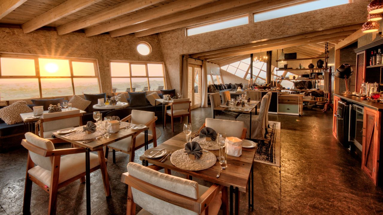 Main dining area at Shipwreck Lodge with desert views through windows