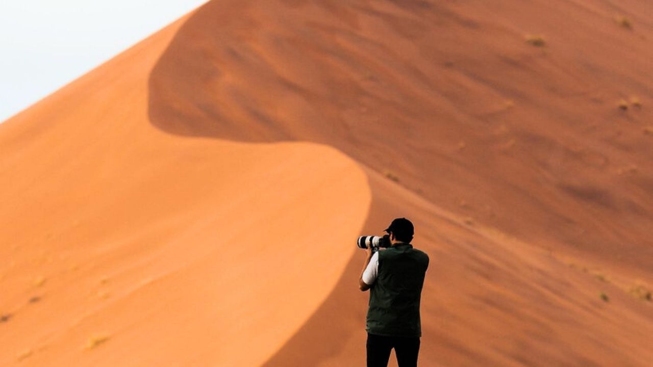 Photographer capturing epic view of Namibian dunes, Sossusvlei