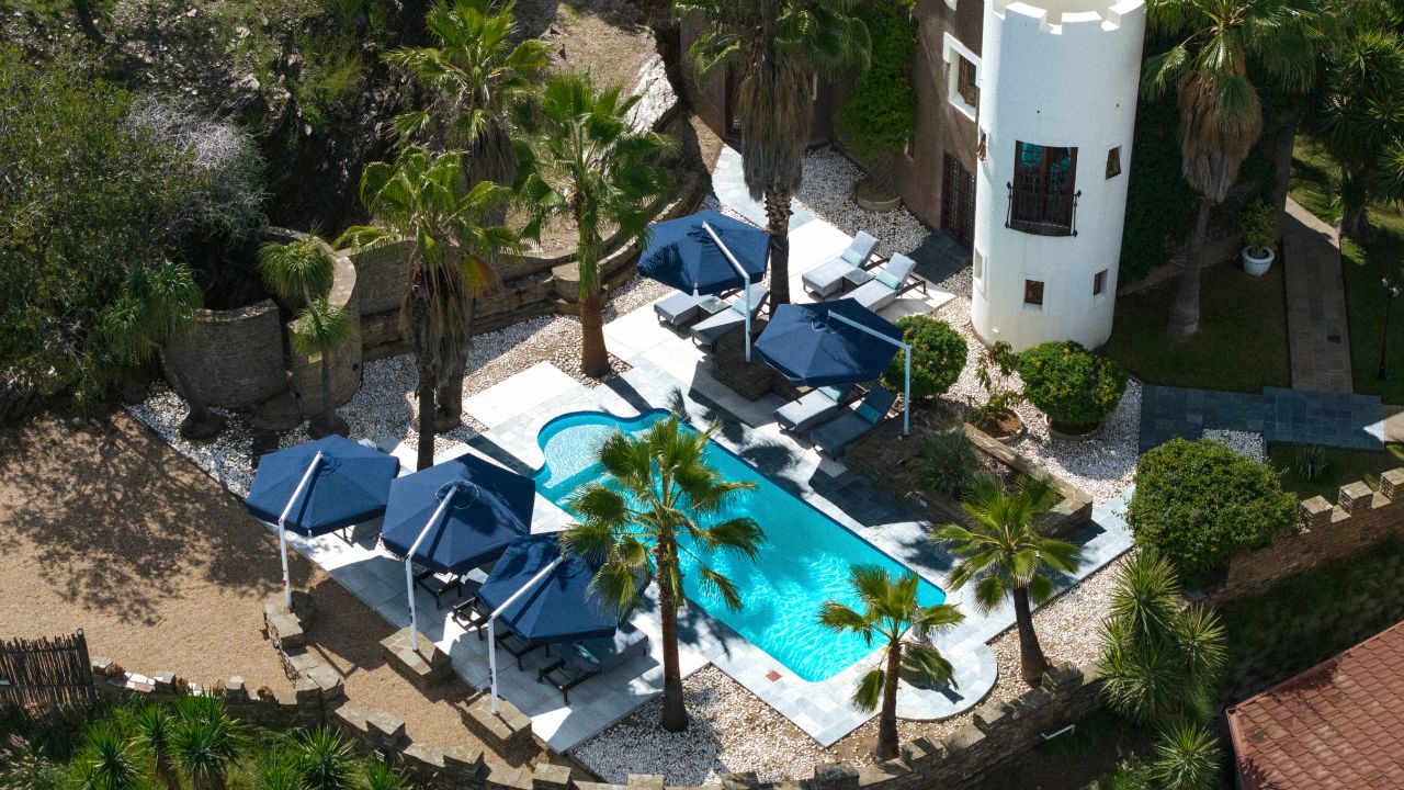 Aerial view of Heinitzburg Boutique Hotel swimming pool and surrounding area