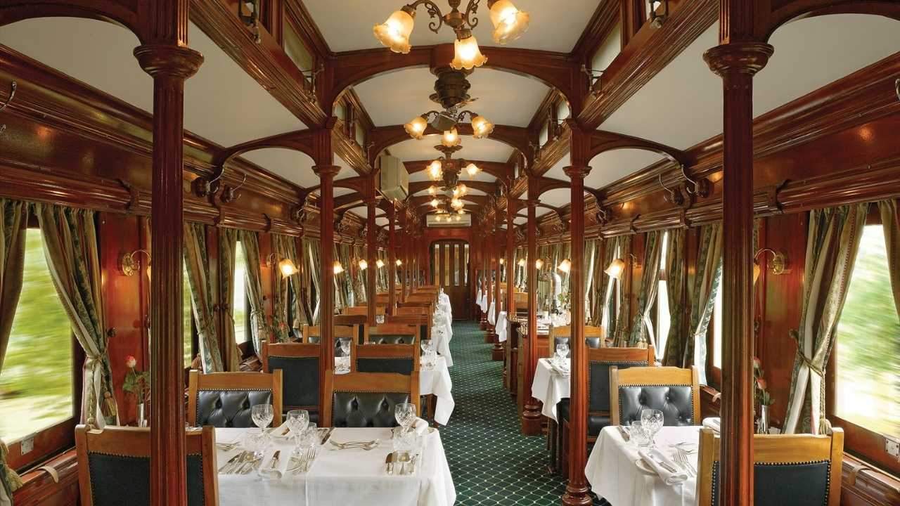 Elegant dining car interior on Rovos Rail luxury train in Africa.