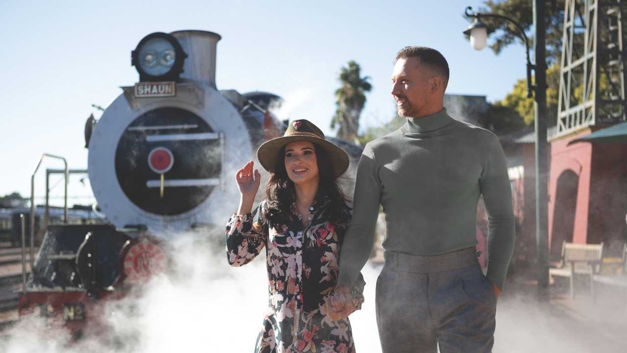 Couple getting off the Rovos Rail train at the station at the end of their journey in South Africa.