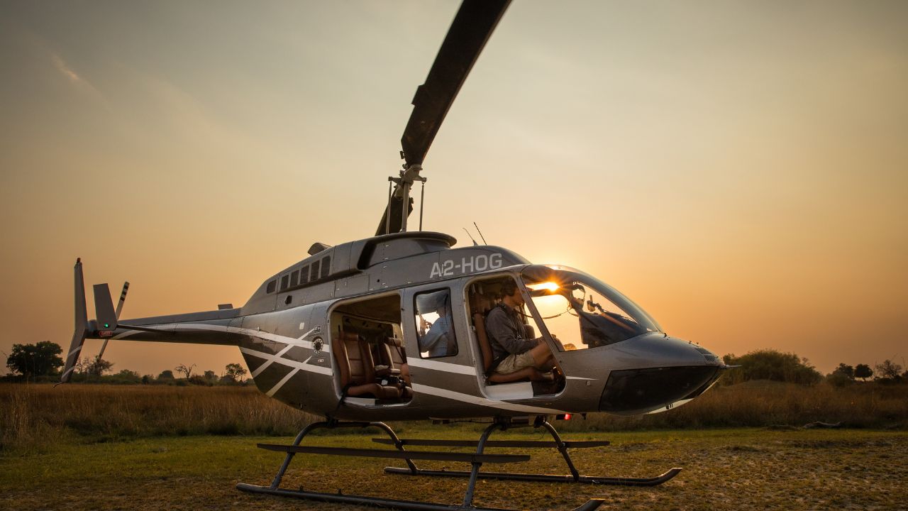 Guests preparing for sunrise helicopter safari flights over the Okavango Delta at Sitatunga Private Island, Botswana.