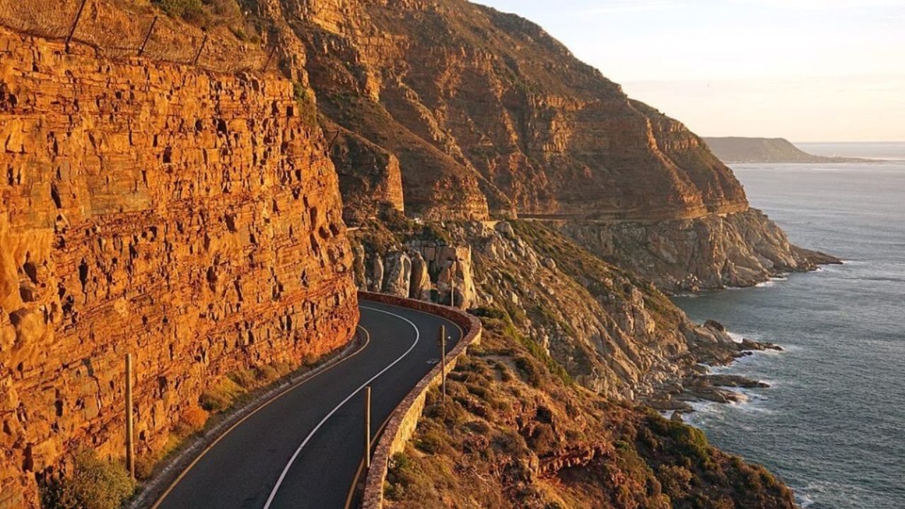 Chapman’s Peak Drive at sunset with ocean on right and mountains on left