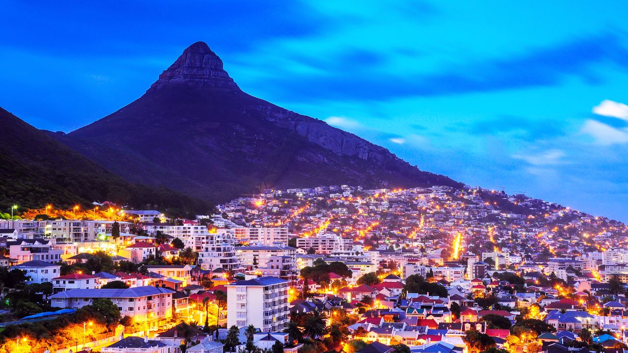 Lion’s Head and Cape Town city lit up in bright evening colors